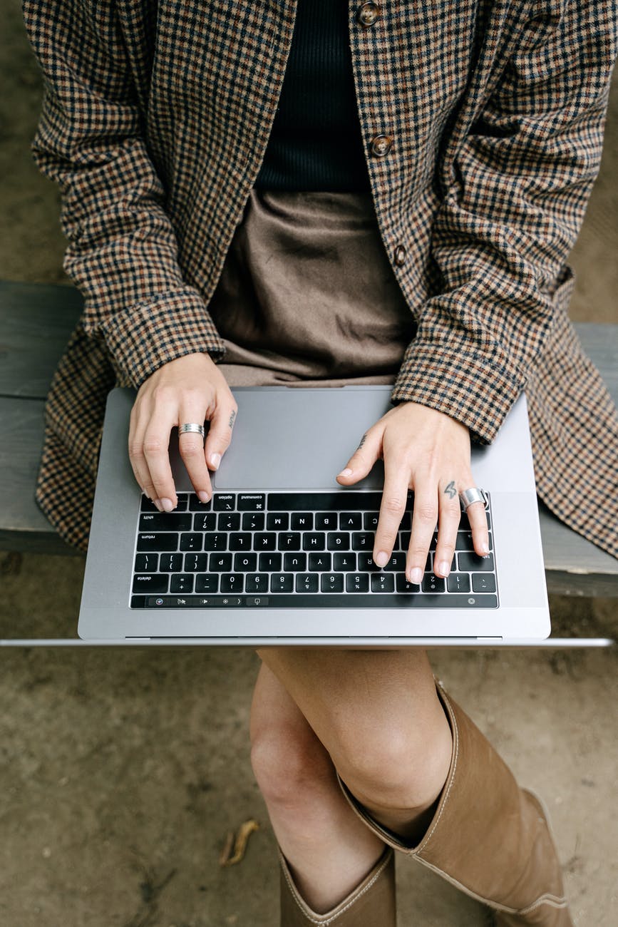 person in gray suit jacket using macbook pro